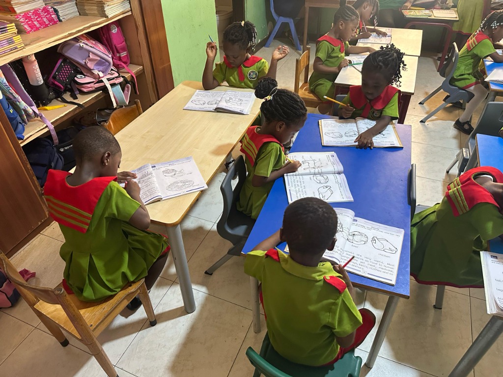 Our Kindergarten 1 students engaged in creative learning activities in their vibrant classroom