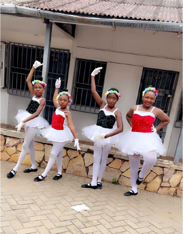 Deacons Academy celebrating victory with trophy and medals - girls with GIGGLE and Twirling Tutus branding